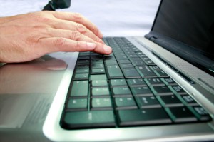 Hand tippt auf Computer Tastatur