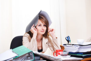 Upset stressed young woman at work