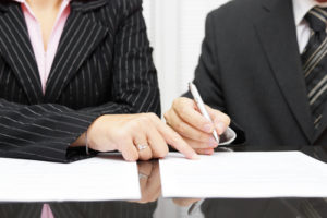 business woman show a businessman to sign a agreement