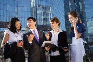 Group of business people meeting outdoor in front of office building