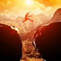Man jumping over precipice