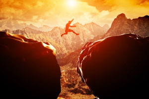 Man jumping over precipice