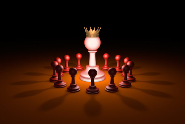 Bauern und König eines Schachspiels stehen für Chef-Metapher