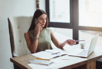 Frau am Computer telefoniert