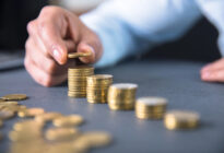 Mann häuft Geldmünzberge an